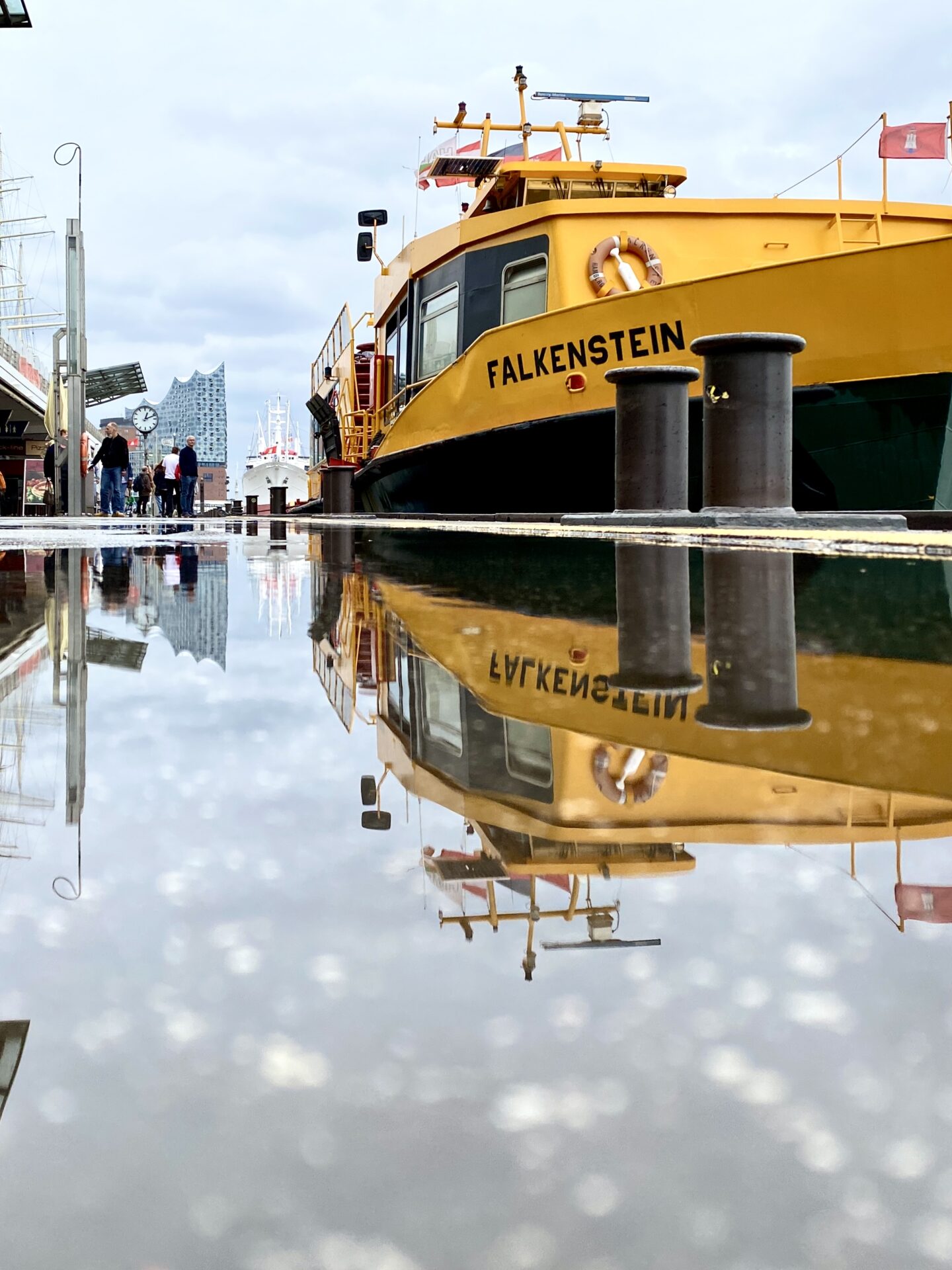 St. Pauli Landungsbrücken, Fähre spiegelt sich in einer Pfütze